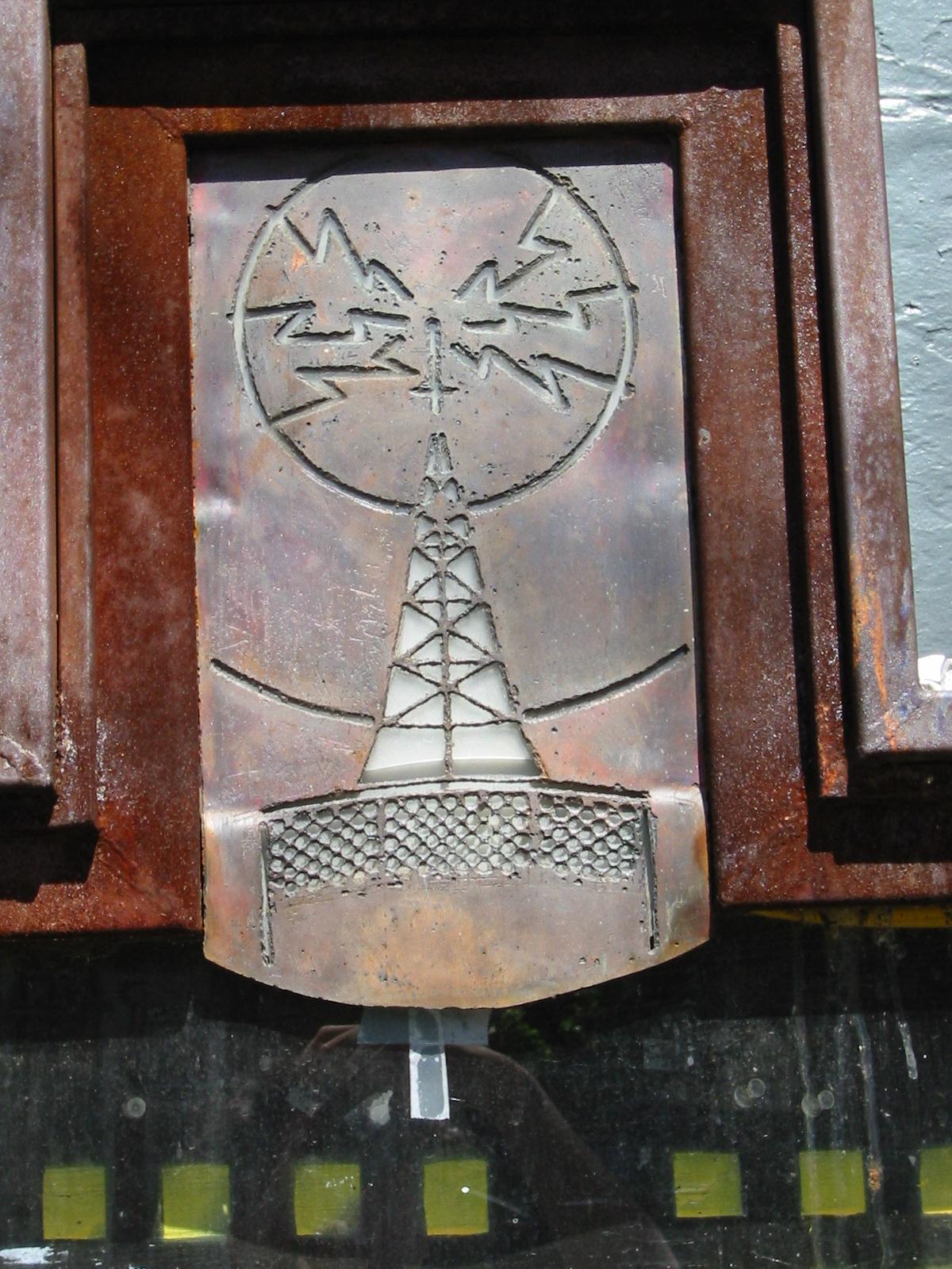 The distinctive metal radio tower sign of the Speakeasy Cafe